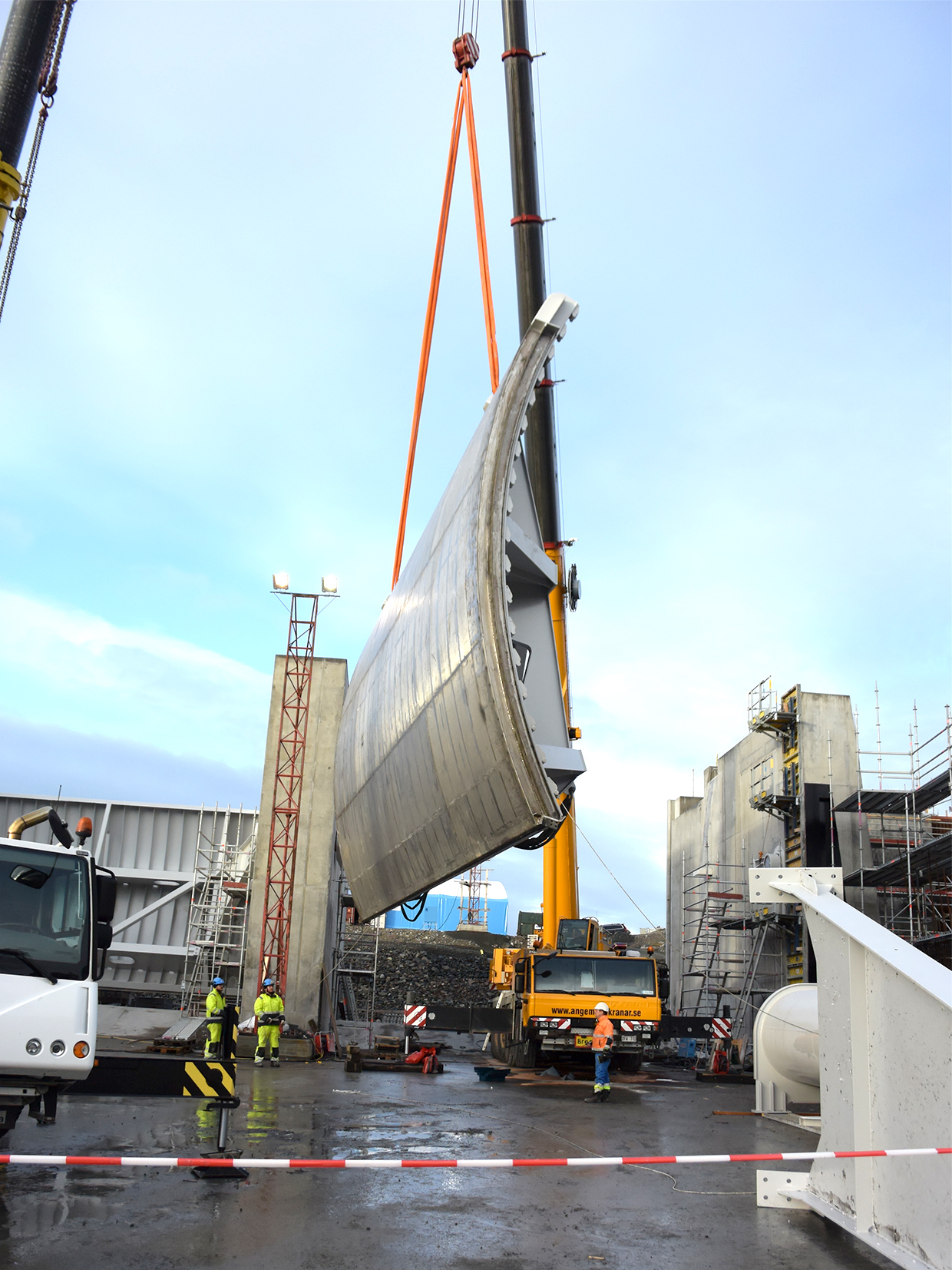Craning a flood gate in position.