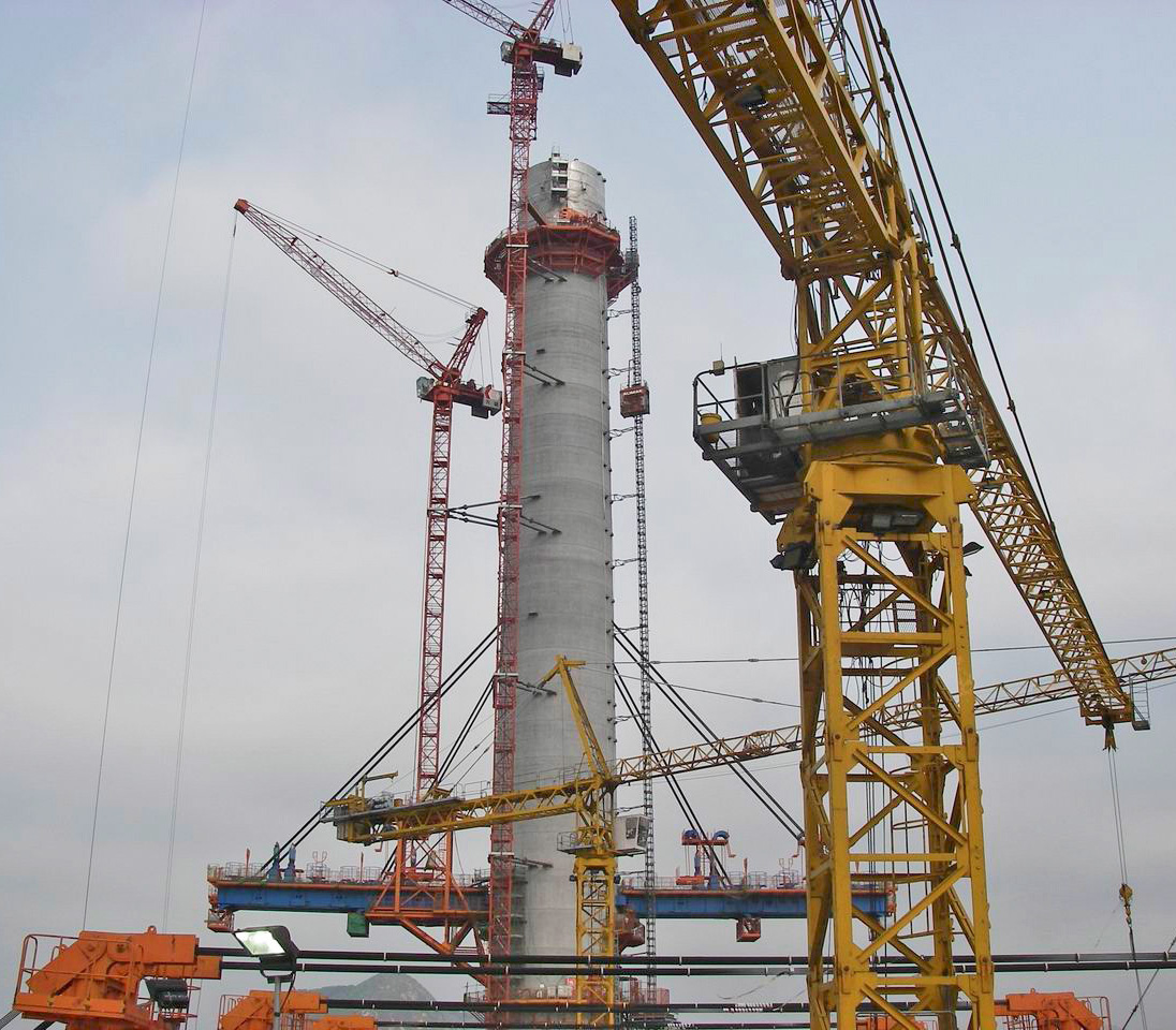 Cranes assembling a tower of the Stonecutters Bridge in Hong Kong, China