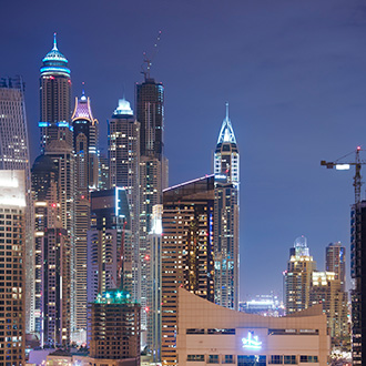 Night view of tall buildings in Dubai